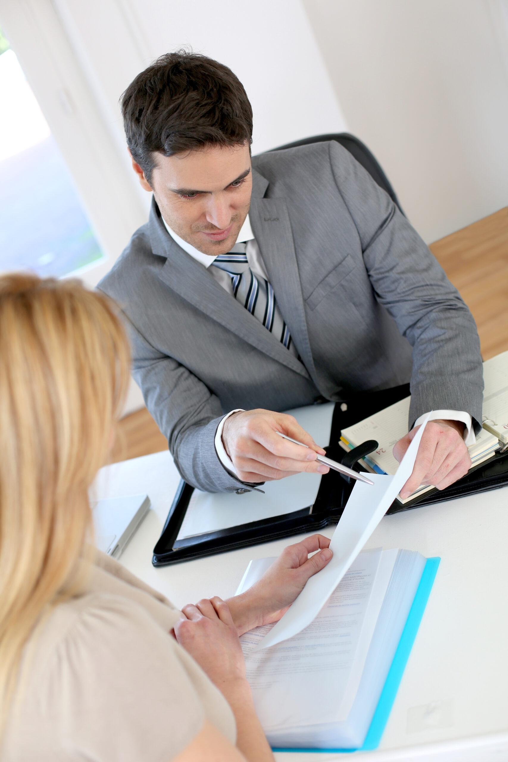 A woman meets with a lawyer to discuss a contract dispute.