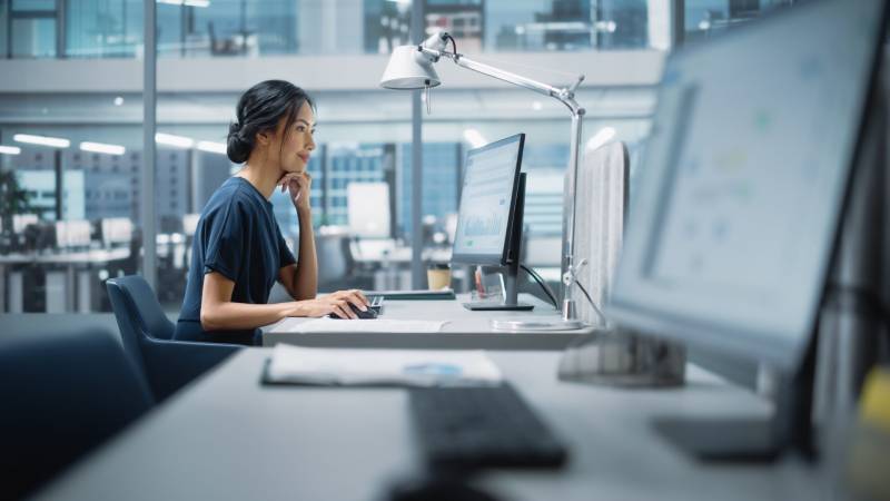 A young solicitor works to handle her client's claim in a modern office.